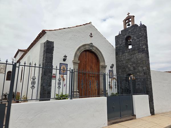 Facade of Ermita de la Viña chapel with volcanic stone bell tower.