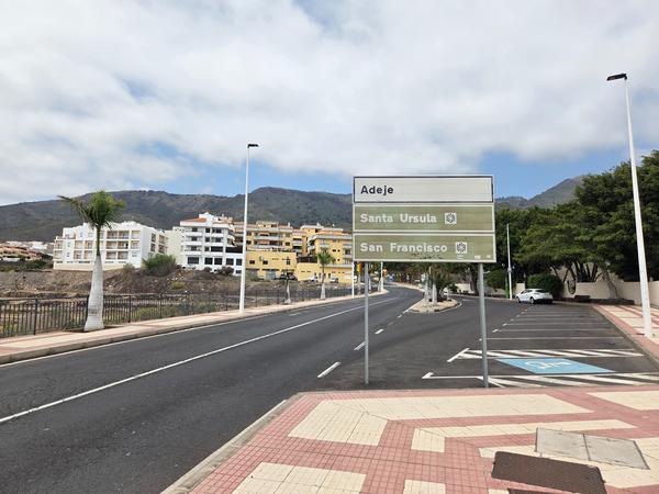 Directional road sign pointing to Adeje, Santa Ursula and San Francisco urbanizations.