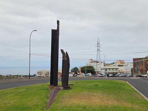 Modern abstract metal sculpture on a green roundabout in Adeje.