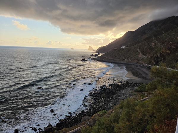 View from the viewpoint above Almáciga, showing black sand beach, cliffs and the ocean.