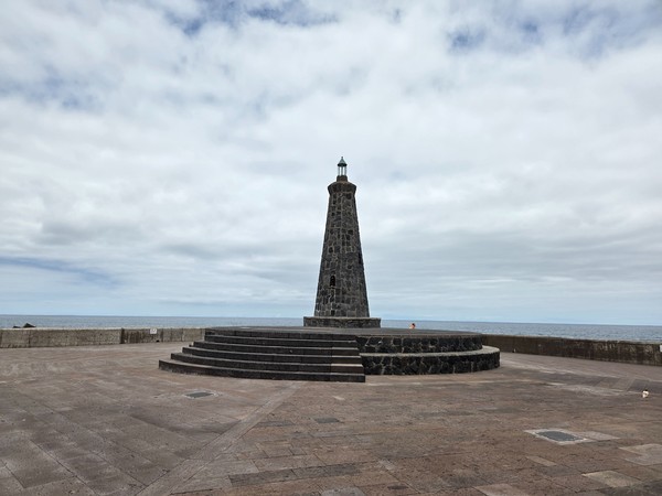 Stone lighthouse monument on the esplanade near the pools of Bajamar.
