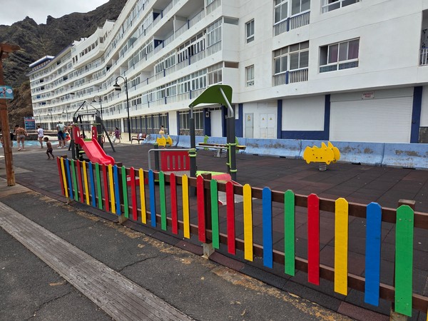 Fenced children's playground by the seafront in Bajamar, next to the pools.