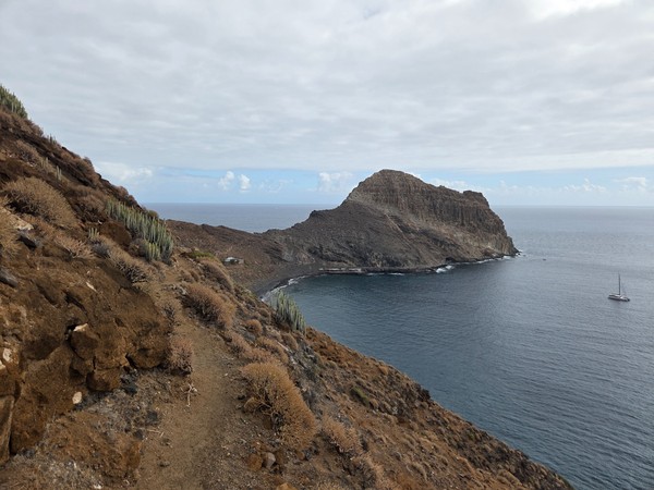 Panoramic view of the Barranco de Zapata bay with a rocky headland and calm Atlantic waters on a cloudy day.