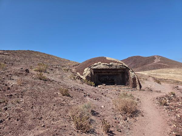 Concrete military bunker from WWII half-buried in volcanic terrain near Montaña Bocinegro, Tenerife.
