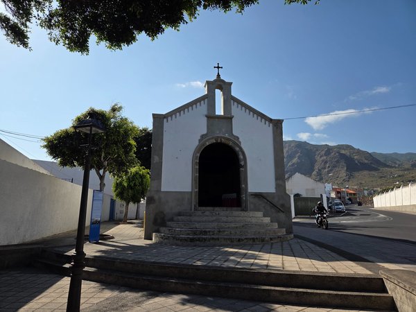 Stone entrance of Ermita de San Sebastián in a quiet corner of town.