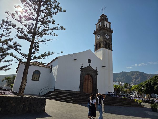 Nuestra Señora de Los Remedios Church with its iconic bell tower and mountain backdrop.
