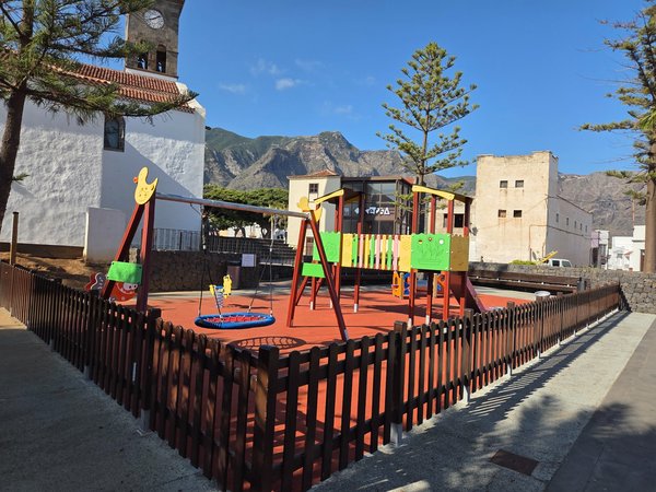 Colorful children’s playground with swings and slides beside the main church.