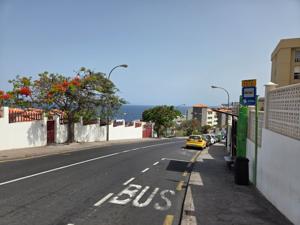 Quiet street with TITSA bus and ocean view