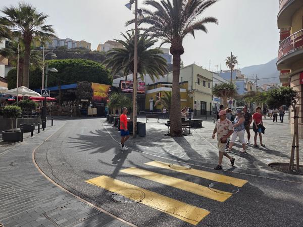 Central square with palm trees and people