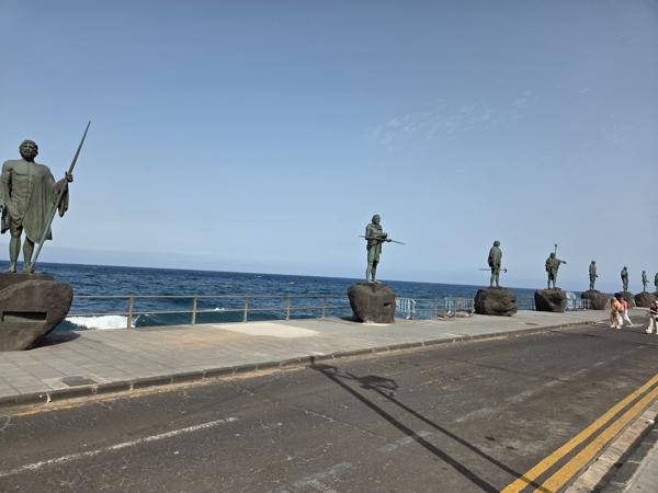 Row of Guanche statues by the sea