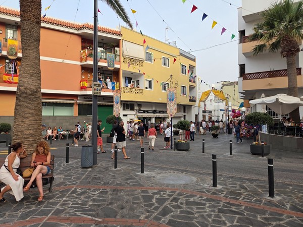 Pedestrian street in Candelaria lined with flags and banners during the fiestas.