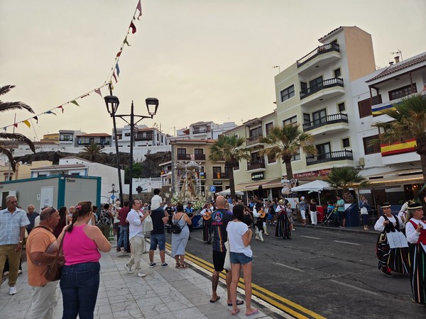 Crowds gather along the waterfront as the procession advances during the Candelaria fiestas.