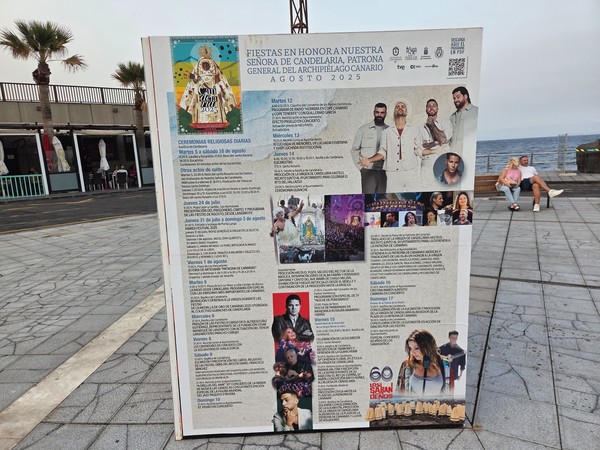 Information board listing the August 2025 Candelaria fiestas schedule and performers by date.