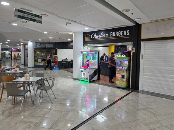 Charlie’s Burgers with arcade machines at the entrance next to the seating area.