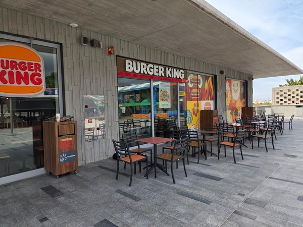Burger King terrace with tables set under the eaves at Rosa Center.
