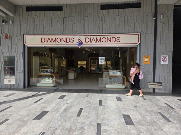 Diamonds & Diamonds jewelry showroom with illuminated cases.