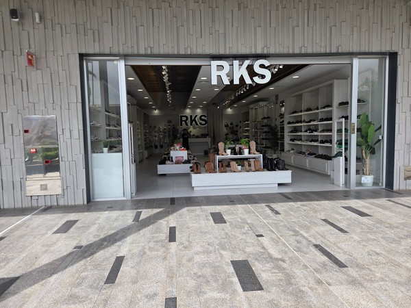 RKS shoe store interior with rows of footwear and central displays.