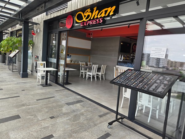 Shan Express Asian eatery with a large menu board and simple seating.