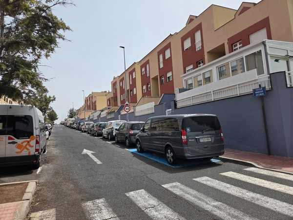 Residential street Calle Wendy Güímar with parked cars and colorful buildings.