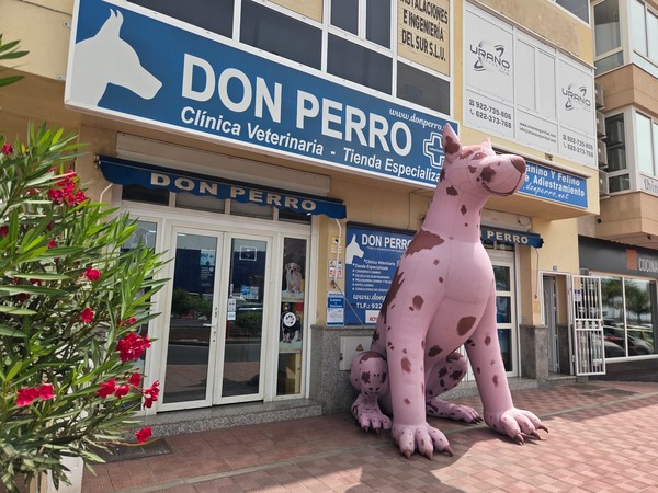 Don Perro veterinary clinic with giant pink dog figure outside.