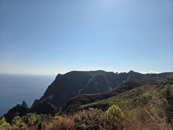 Mountainous ridges and valleys surrounding Chinamada with a view toward the sea.