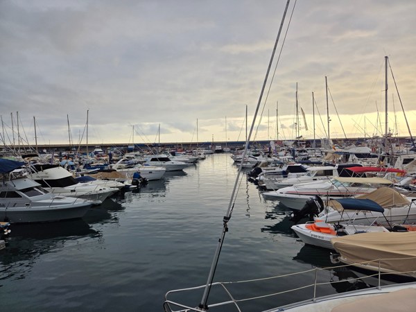 Boats moored in Puerto Colón marina at dusk in Costa Adeje.