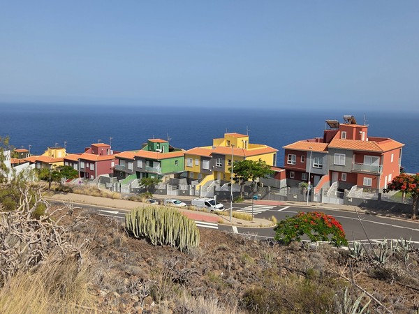 Row of colorful hillside houses in Costanera looking out to the blue Atlantic.