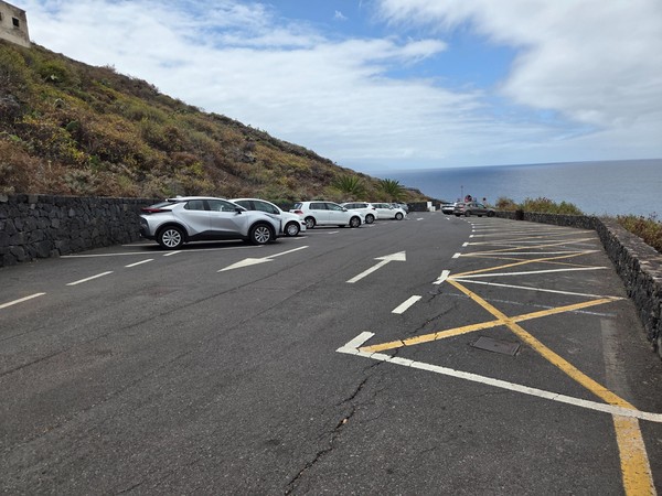 Upper parking area with marked bays above the cliffs and an open Atlantic view.