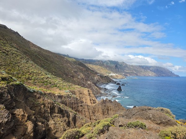 Wide-angle view from a cliff-top mirador overlooking the Anaga coast and rugged sea stacks near Roque de las Bodegas.