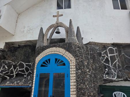 Tiny seaside chapel decorated with volcanic stones