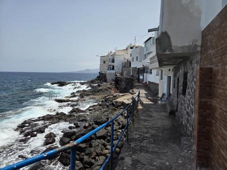 Oceanfront walkway between cliffside houses