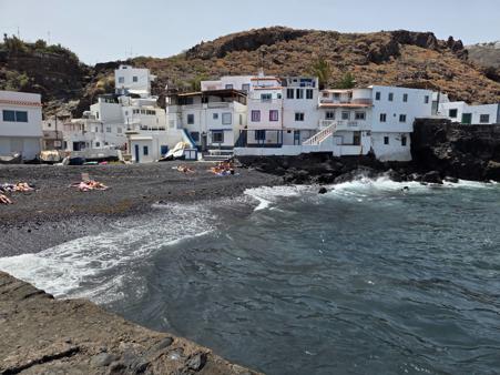 Sunbathers enjoying the volcanic beach in town