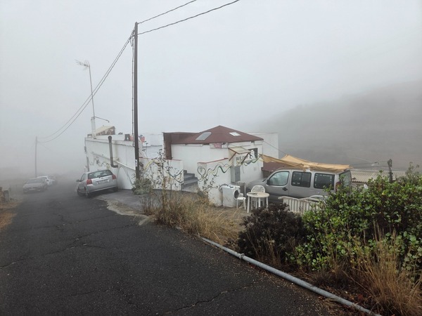 Small rural bar and houses near the El Contador trail on a misty morning.