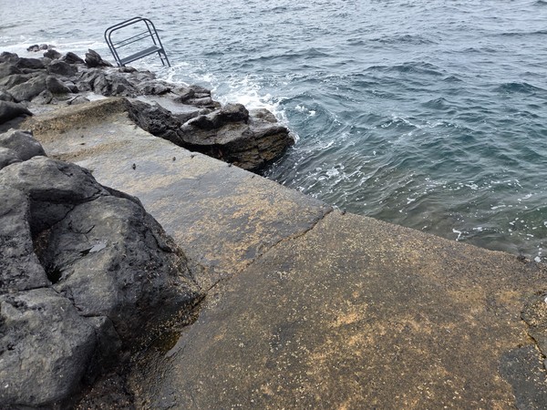 Metal sea ladder fixed to the rocks at El Marquéz providing a safe step into the water.