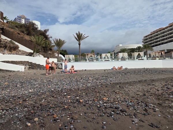 Apartment complexes and hotels overlooking the small cove of Playa El Pinque.