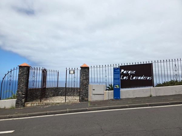 Entrance gate and viewpoint sign for Parque Los Lavaderos above the Atlantic.
