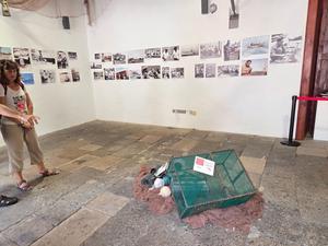 Fishing exhibit with historical photos and traditional gear inside a Garachico museum.