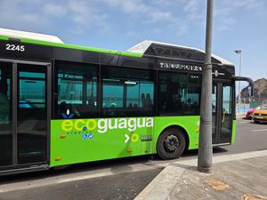 Eco-friendly hybrid bus from Titsa in Garachico, Tenerife, parked near the coast.