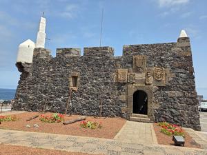 San Miguel Castle in Garachico, made of volcanic rock with historical coats of arms.