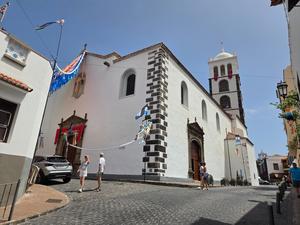 Church of Santa Ana in Garachico decorated with flags during local festivities.