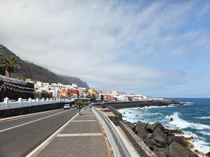 Coastal promenade in Garachico with waves crashing against the volcanic rocks.