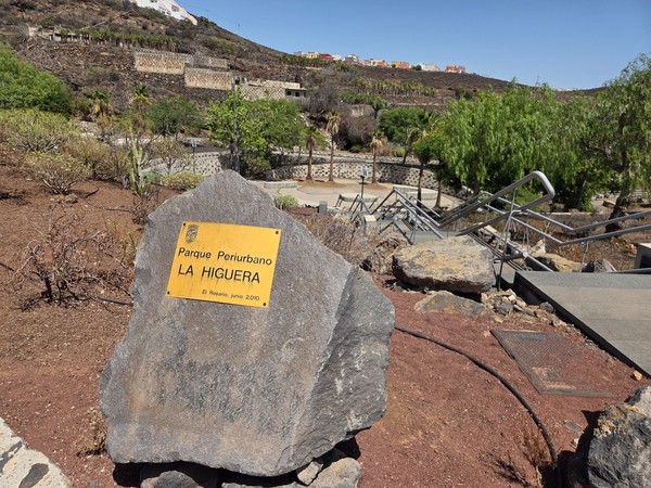 Entrance marker of Parque Periurbano La Higuera in El Rosario with terraced slopes and stairways built into the volcanic hillside.