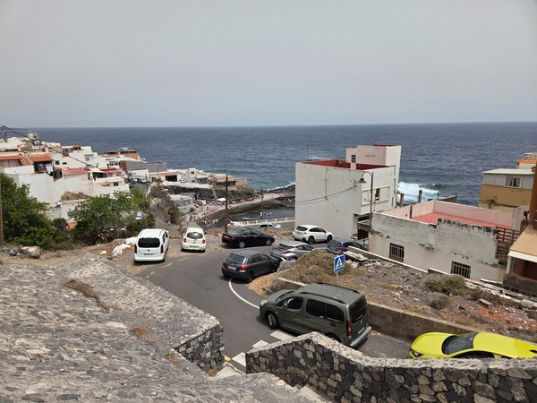 Terraced houses stepping down to the coast with parking areas in La Caleta de Punta Prieta.