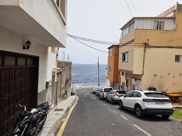Narrow downhill lane leading to the seafront in La Caleta de Punta Prieta.