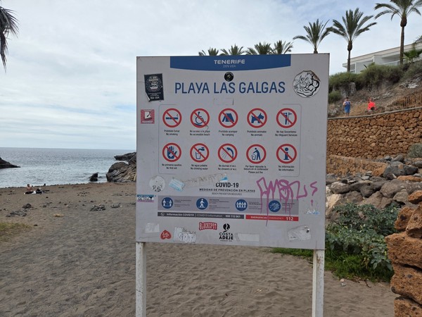 Information board with beach rules at Playa Las Galgas, Costa Adeje.