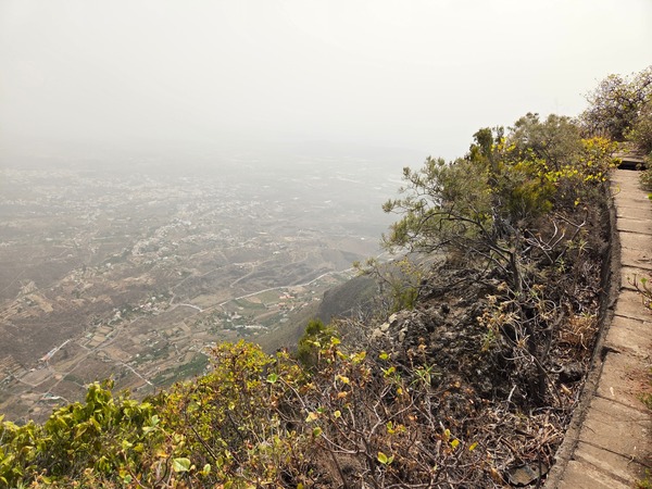 Cliff-edge walkway of the gallery with expansive views over the terraces and villages far below.