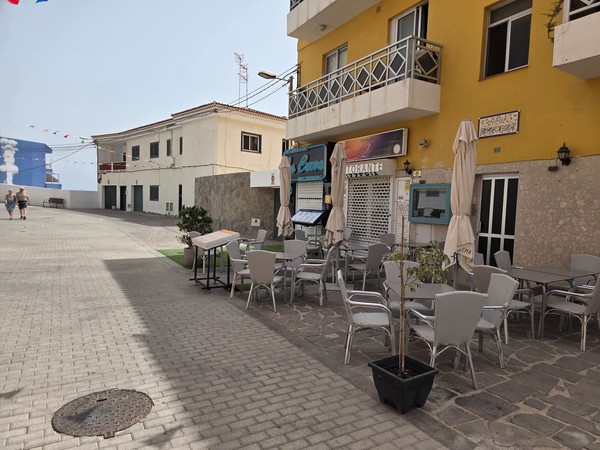 Outdoor terrace of a seafront café and pizzeria in Los Abrigos Tenerife.