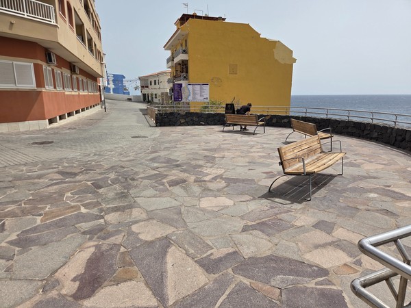 Los Abrigos main square decorated with colorful flags and a stage setup for the annual fiesta.
