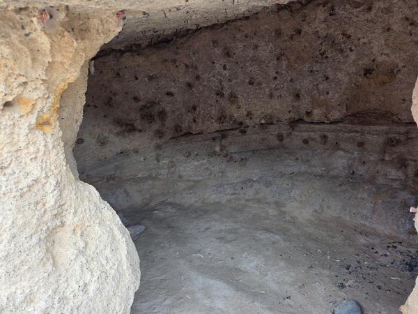 Interior of Cueva La Tabona showing its arched walls and ancient rock texture.