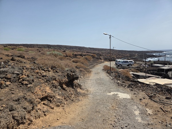 Small seafront parking area and track at the edge of the Malpaís de Güímar route.